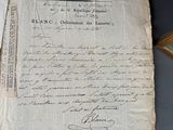 an old document with writing on it sitting on a table