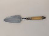 a small spatula with a wooden handle on a table