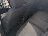 the interior of a small car with two seats and a steering wheel