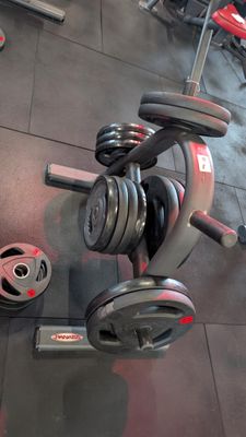 a gym room with dumbs and weights on the floor