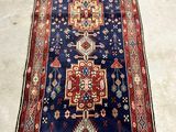 an image of a long blue rug with a red border