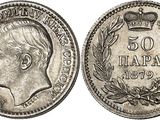 a silver coin with a crown on top of it