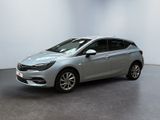 a silver opel parked in a white room with a black floor