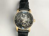 a close up of a watch on a white surface with a black strap