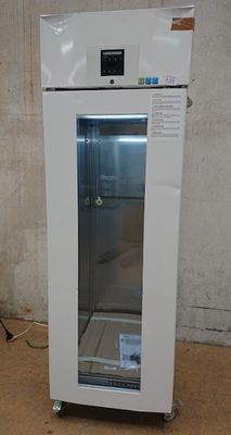 an image of a white refrigerator in a dirty room