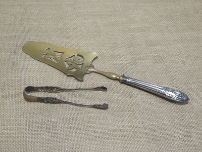 a silver spoon and two silver spoons sitting on a table