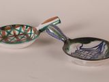 two small bowls and a spoon on a table