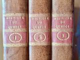 three old books sitting on a shelf next to each other