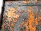 a close up of a piece of wood with rust on it