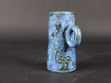 a small blue vase with a handle on a table