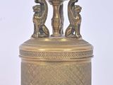 un vase en or surmonté de deux oiseaux