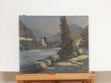 a painting on a easel with a painting of a river in the background