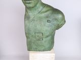 sculpture of a man ' s head on a marble base with a white background
