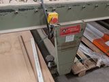 a machine that is working on a piece of wood