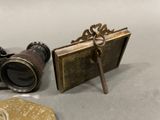 a pair of binoculars sitting next to a book and a key