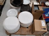 a lot of plates and bowls sitting on a pallet