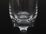 a close up of a glass on a table with a black background
