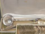 a box with silverware inside of it on a table