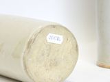 two vases sitting next to each other on a white surface
