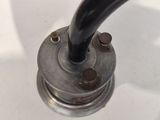 a black pipe sticking out of the top of a sink faucet