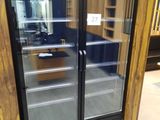 a refrigerator that has two glass doors in it