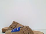 a close up of a pair of sandals on a white surface