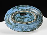 a blue plate sitting on top of a white table