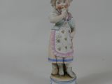 une figurine représentant une petite fille debout sur une boîte