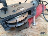 someone is using a circular saw to cut a hole in a piece of plywood