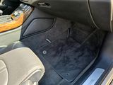 the interior of a car with the door open and the floor mat down
