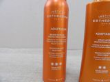 an image of two bottles of sun tanning lotion sitting on a table