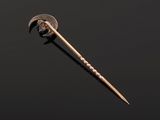 a close up of a small metal object with a long blade