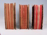 three books are stacked on top of each other on a table