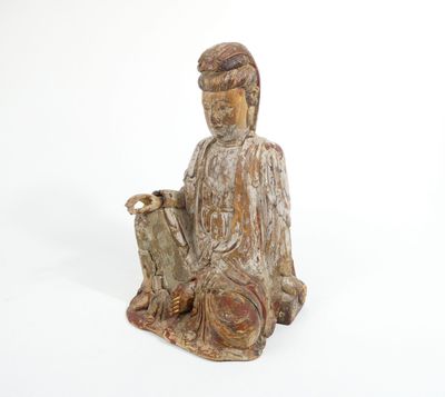 statue of a person sitting on the ground with a dog