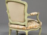 a green chair with a beige upholstered seat and a beige upholstered back
