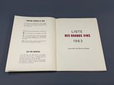 an open book with a picture of a red and black logo on it