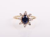 a blue sapphire and diamond ring on a white background