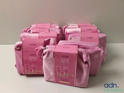 four bags of pink toiletries are lined up on a table