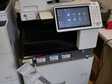 many printers and scanners sitting on a desk