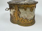 a gold and marble box on a white surface