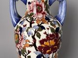 a vase with a floral design on it on a table