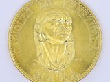 an image of a gold coin with a woman ' s face on it