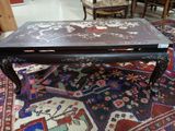 a coffee table that is on a rug in a room
