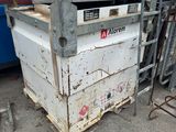a dumpster that is sitting in front of a blue dumpster