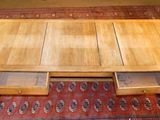 a wooden table with two drawers underneath it