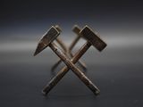 two hammers sitting on top of each other on top of a table
