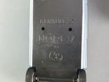 a close up of a metal object on a white surface