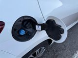 an electric car plugged into a charging station on the street