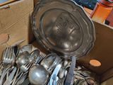 a box full of silver spoons and forks