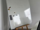 a white board on the wall next to a computer